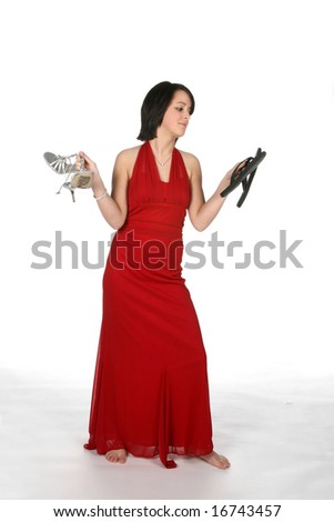 teenage girl holding two pairs of shoes, trying to decide which to wear