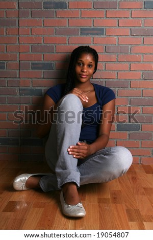 The Walking Dead Stock-photo-attractive-black-teenage-girl-sitting-on-the-floor-and-leaning-against-a-brick-wall-19054807