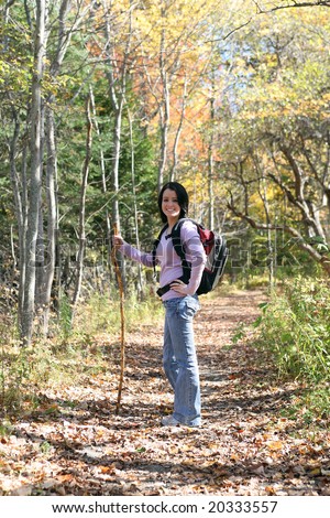 pretty teenage girl hiking outside in the fall