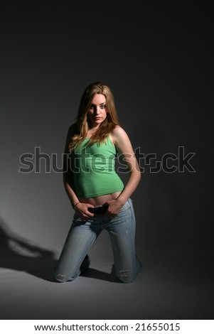 sexy young woman in tight green shirt and low jeans