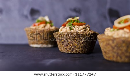 vegan raw food quiche with nut filling and vegetables on top