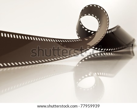 slightly rolled undeveloped film strip on a glossy surface
