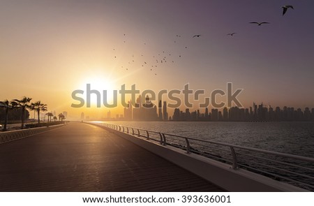 empty boardwalk in the morning sun with the skyline of Dubai in the background, Dubai, UAE