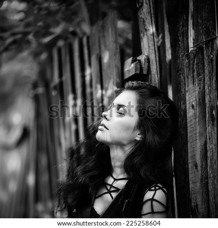 Art portrait of young gorgeous brunette outdoors. Shallow depth of field. Black and white