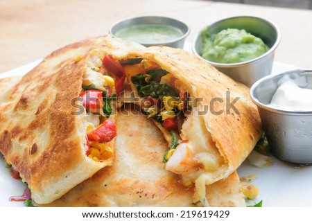 Grilled Shrimp Quesadilla with sour cream, guacamole and salsa verde.