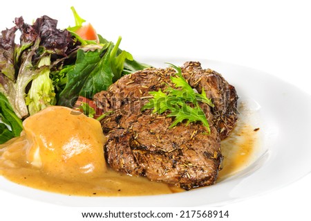 Rump steak with mashed potatoes and mix vegetable on plate isolated on white background