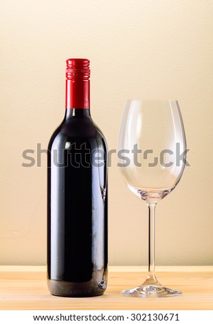 Still life with Bottle red wine with glass of wine on wooden table