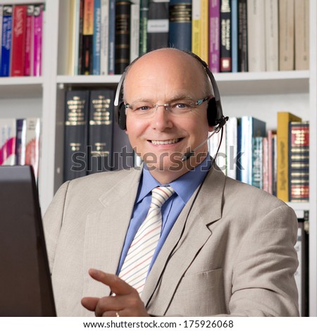 Experienced employee of customer service with headphones smiling happily