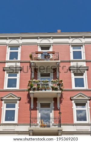 Renovated historical apartment building in front of blue sky, copy space, frontal view