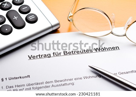 Contract about a nursing service on an outpatient basis with calculator, reading glasses and ballpoint pen, vertrag betreutes wohnen