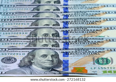 Currency of the United States one hundred dollars banknotes useful as a background. Perspective view.