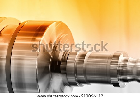 Rotating spindle of turning lathe and metal detail. Selective toning.