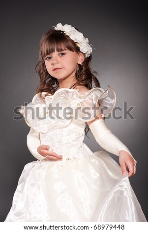 Beautiful little princess dancing in luxury dress