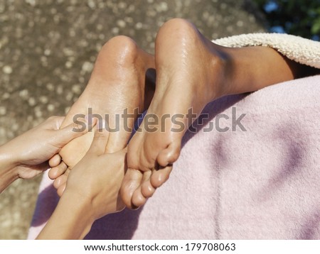 Beautiful black woman legs being massaged at spa