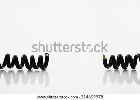 Cut vintage telephone cord on white background