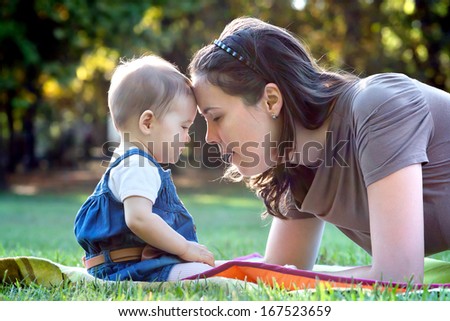 Beautiful young mother and her cute baby in the park.