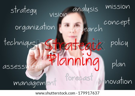 Young business woman writing strategic planning concept.