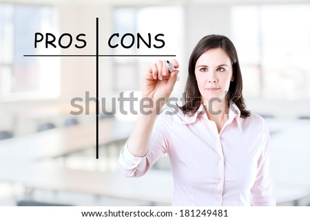 Young businesswoman holding a marker and writing pros and cons comparison concept. Office background.