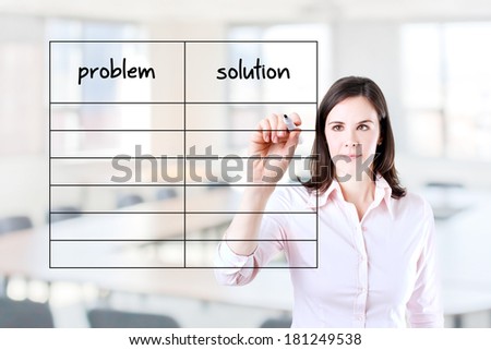 Young business woman writing problem and solution list in blank. Office background.
