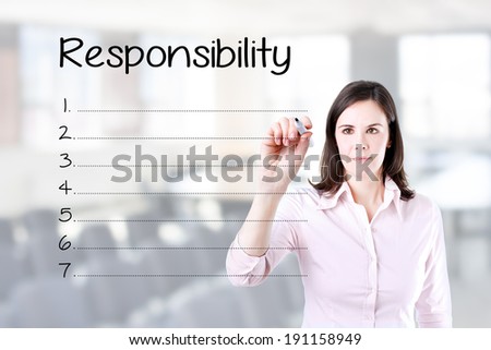 Business woman writing responsibility list in blank. Office background.