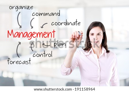 Business woman writing management skill and responsibility. Office background.