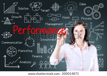 Young businesswoman writing performance business scheme. Blue background.