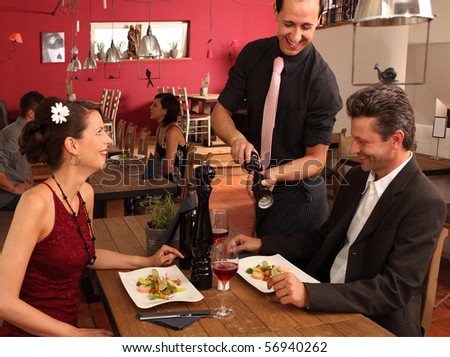 nice dinner in a restaurant - waiter offers pepper