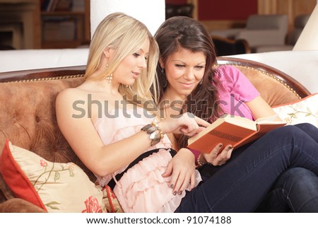 teenager girls reading a book - friends