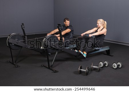 sport people on a rowing machine