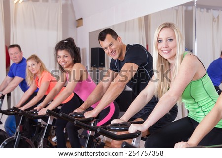 spinning - cycling group of fitness people
