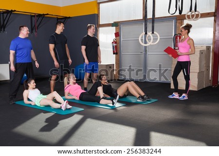 Sports people preparing for exercise and looking at coach