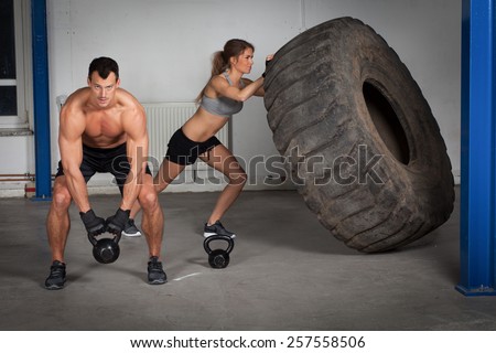 crossfit training - woman flipping tire