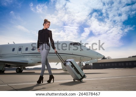 executive business woman leaving a corporate jet plane