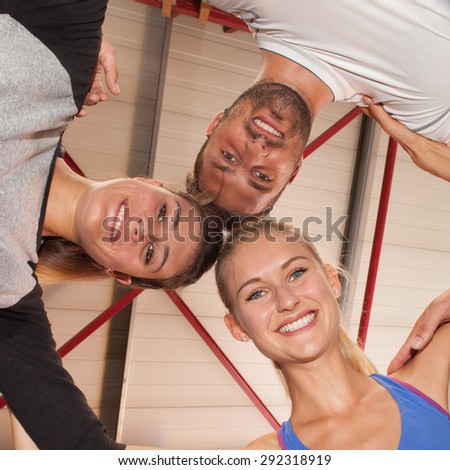 Heads together - fitness team in a gym
