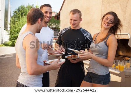Friends having a barbecue after fitness work out