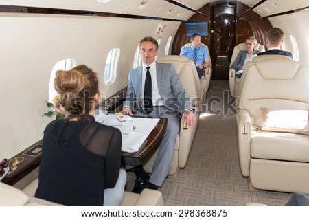 business team traveling in corporate jet