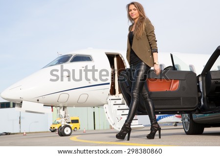 woman convertable car and corporate private jet