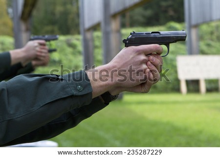 people aiming guns in shooting range