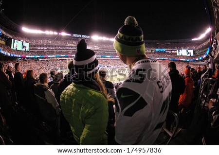 A Couple Looks Out Towards The Field During The Super Bowl Xlviii Pre-Game Show At Metlife Stadium In East Rutherford, New Jersey Feb. 2, 2014. The Seattle Seahawks Defeated The Denver Broncos 43-8.