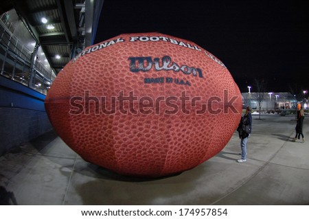 A Giant Inflatable Wilson Nfl Football Outside Metlife Stadium In East Rutherford, New Jersey Feb. 2, 2014 For Super Bowl Xlviii. A Fan Poses For A Photo. The Seattle Seahawks Beat The Denver Broncos.