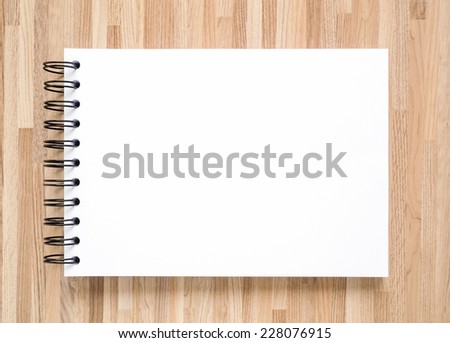 Blank notebook for painting, drawing and sketching on wood background.
