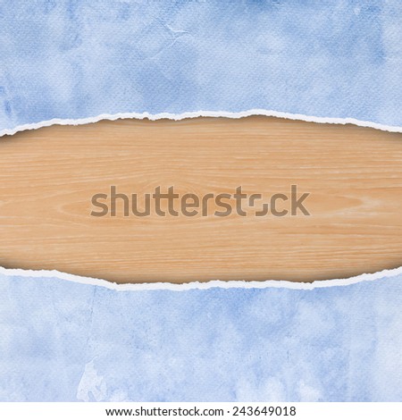 Ripped blue paper texture and wood background