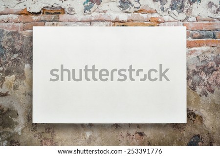 White canvas frame for art idea on grunge vintage brick wall background.