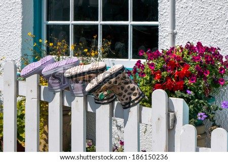 STAITHES, NORT YORKSHIRE/UK - AUGUST 21 : Two pairs of boots placed on fence posts in Staithes North Yorkshire on August 21, 2010