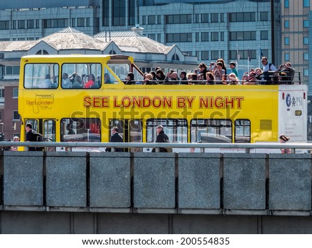LONDON, UK - JUNE 14 : Tourist bus on London Bridge in London on June 14, 2013. Unidentified people.