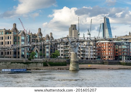 LONDON - JUNE 25 : The Millennium bridge in London on June 25, 2014. Unidentified people.