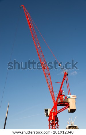 LONDON - DECEMBER 6 : Red crane operating in London on December 6, 2013