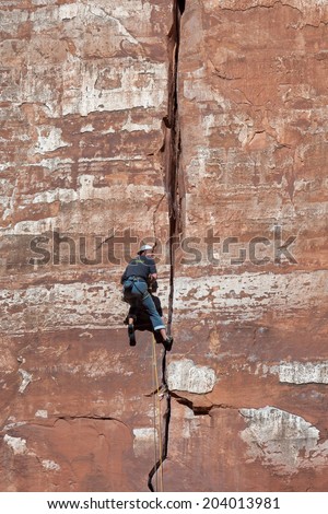 ZION NATIONAL PARK, UTAH/USA - NOVEMBER 4 : Man climbing sheer rock face in Zion National Park Utah on November 4, 2009. Unidentified man.