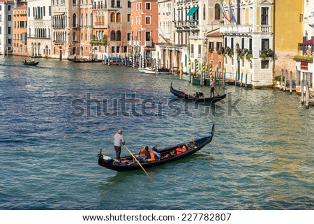 VENICE, ITALY/EUROPE - OCTOBER 12 : Gondoliers plying their trade on the Grand Canal in Venice Italy on October 12, 2014. Unidentified people.