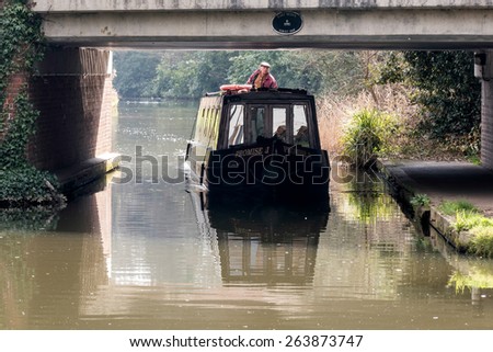 SEND, SURREY/UK - MARCH 25 : Narrow Boat on the River Wey Navigations Canal near Send in Surrey on March 25, 2015. Unidentified man.